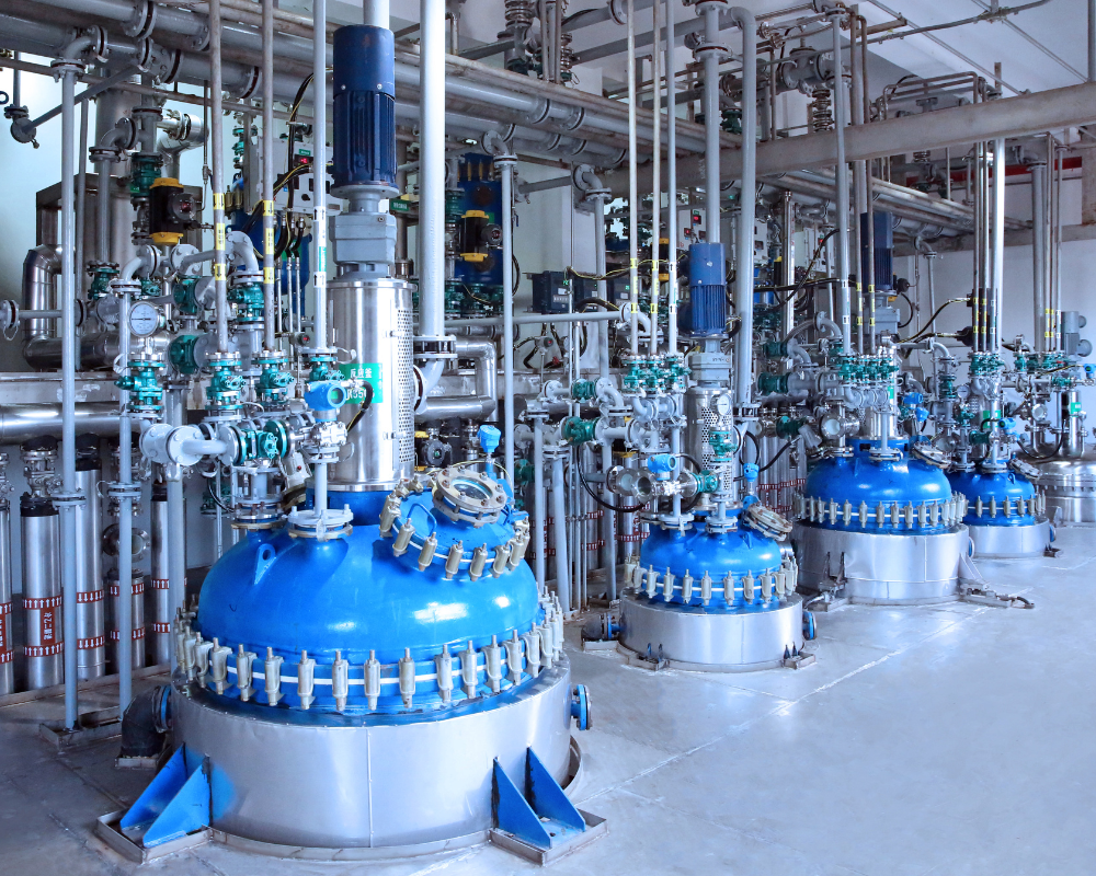 Five blue large scale reactors in manufacturing suite at Apeloa CDMO for scalable synthetic chemistry.